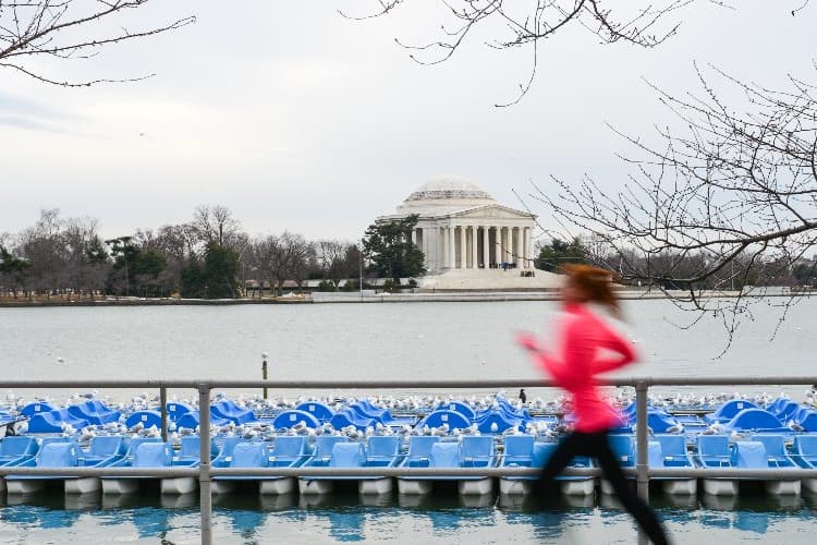 a woman runs past the Jefferson memorial in dc