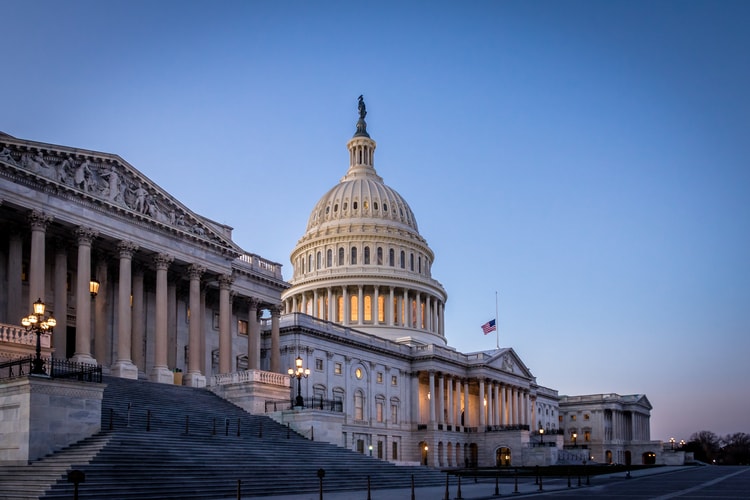 a view of the capitol building from the side at dusk