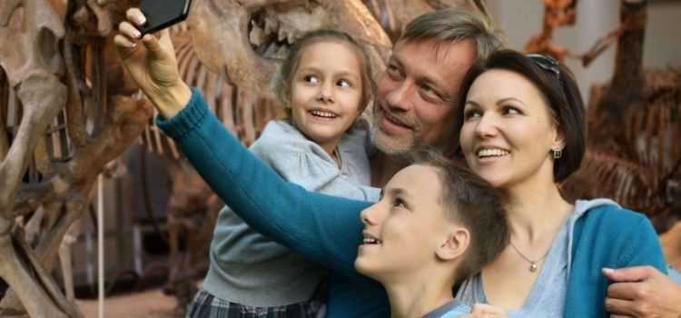 Portrait of happy family taking selfie with smartphone