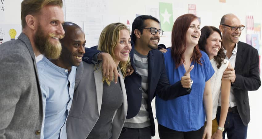 A group of colleagues smiling for a photo together