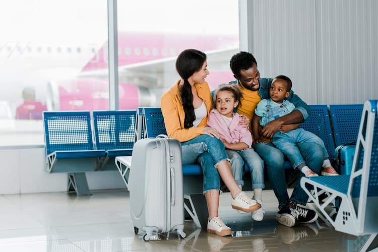 Family sitting in waiting area at airport