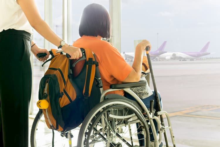 Older woman in wheelchair at airport