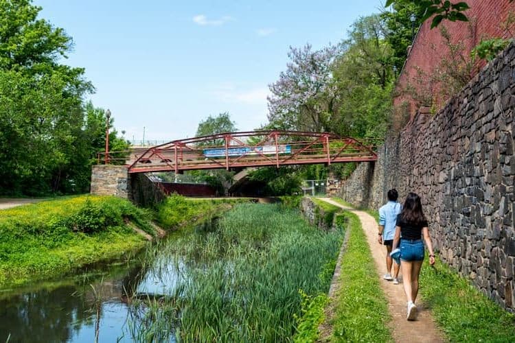 Two women walking by Georgetown canal